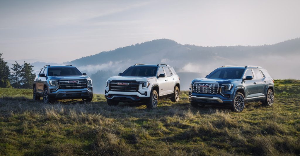 2026 GMC Terrain SUV navigating dirt road in wooded landscape highlighting all-terrain performance