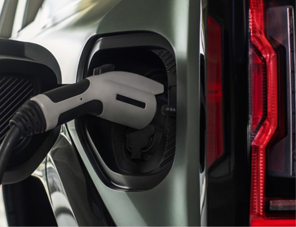Close up of charging port with charger plugged in on a GMC Hummer EV SUV - Kightlinger Motors GMC in COUDERSPORT PA